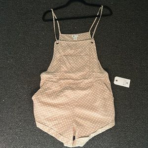 Tan polka dot Billabong romper/overalls with pockets and tie straps